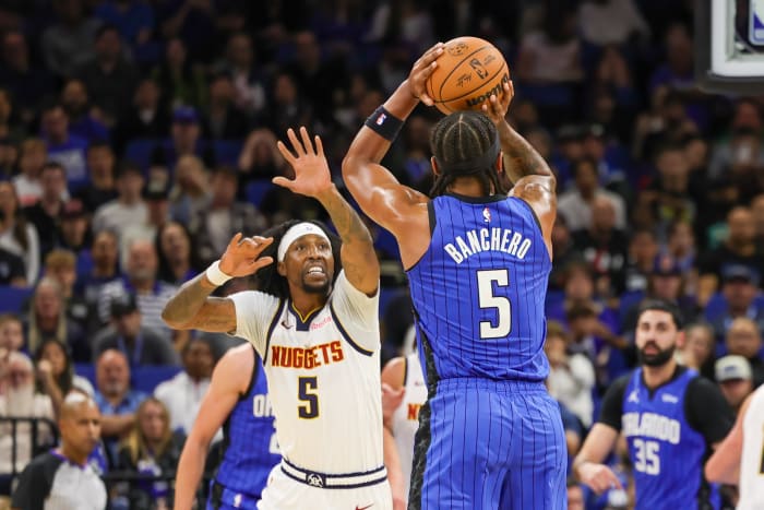 Orlando Magic forward Paolo Banchero (5) shoots the ball against Denver Nuggets guard Kentavious Caldwell-Pope (5) during the first quarter at Amway Center.